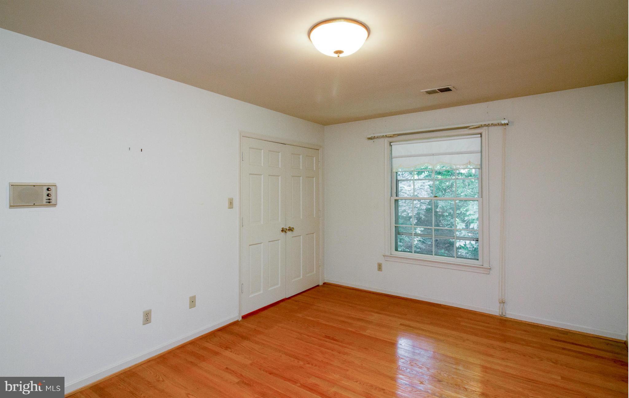 6033 Chesterbrook Road McLean, VA 22101 - Photo 14 of 24 an empty room with wooden floor and windows