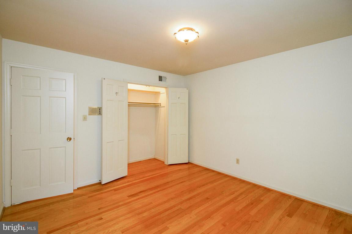 6033 Chesterbrook Road McLean, VA 22101 - Photo 15 of 24 a bedroom with a bed and a table in it