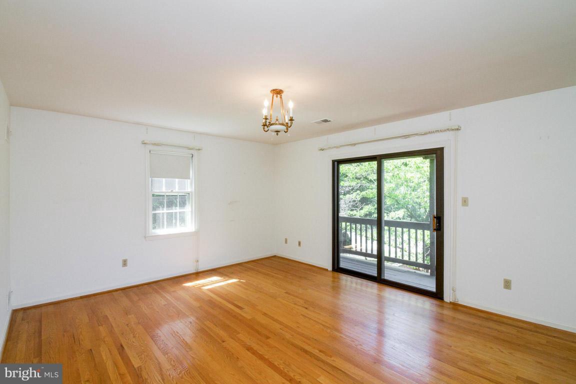6033 Chesterbrook Road McLean, VA 22101 - Photo 18 of 24 wooden floor in an empty room with a window
