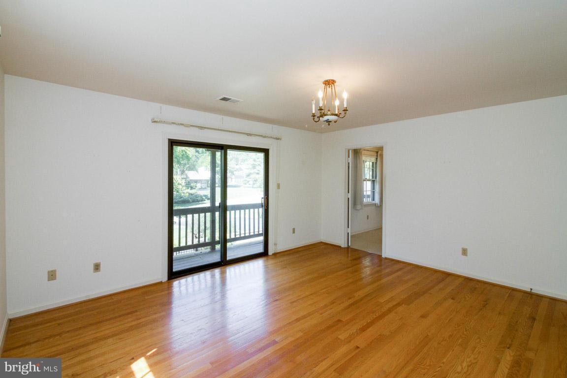 6033 Chesterbrook Road McLean, VA 22101 - Photo 19 of 24 wooden floor in an empty room with a window