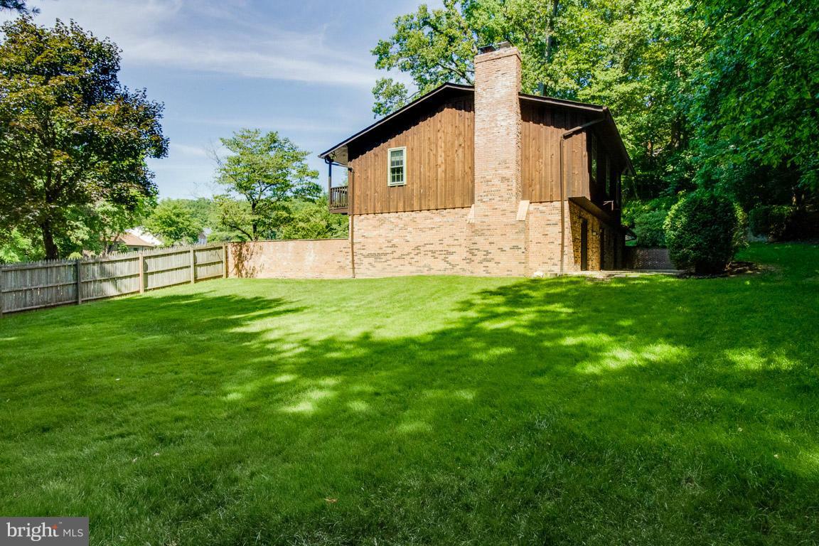 6033 Chesterbrook Road McLean, VA 22101 - Photo 22 of 24 a view of front of house with a yard