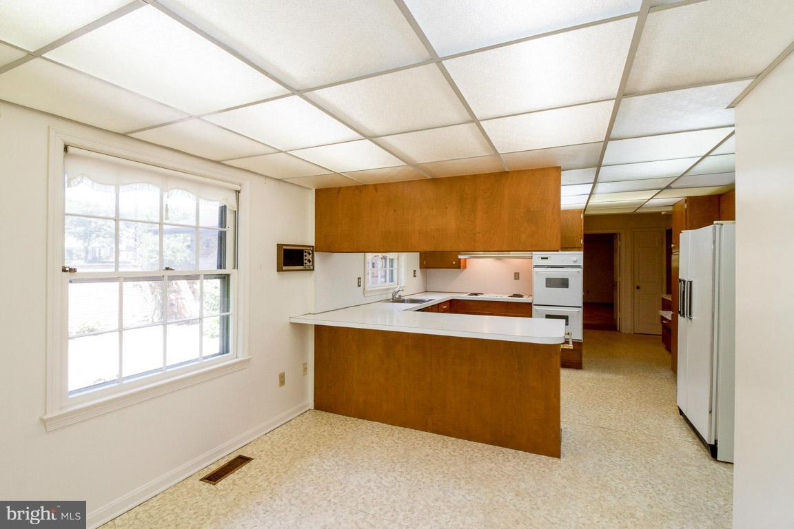 6033 Chesterbrook Road McLean, VA 22101 - Photo 4 of 24 a view of a kitchen with a sink dishwasher and a refrigerator