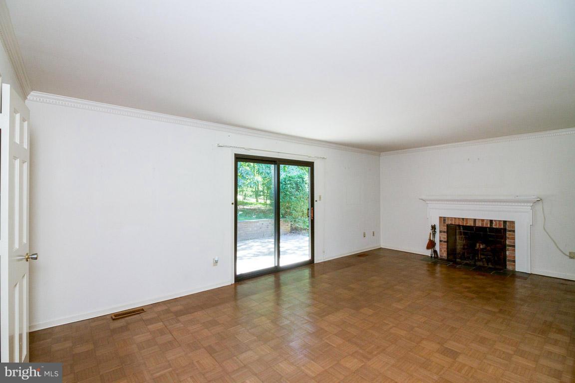 6033 Chesterbrook Road McLean, VA 22101 - Photo 8 of 24 an empty room with fireplace and a window