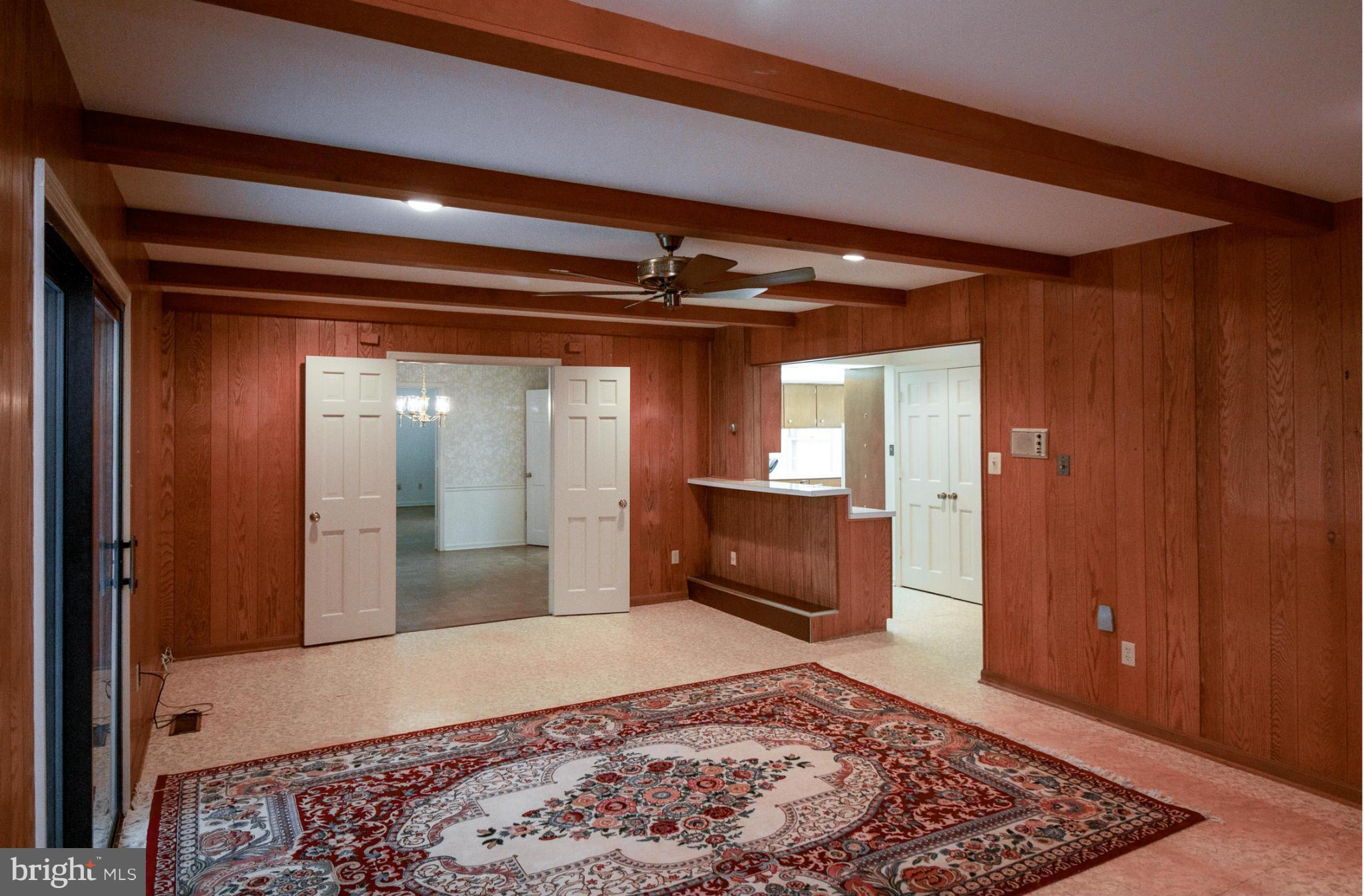6033 Chesterbrook Road McLean, VA 22101 - Photo 9 of 24 a view of a hallway with a couch and wooden floor