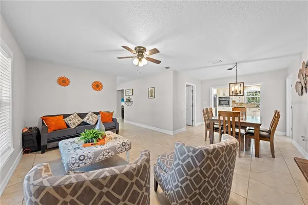 a spacious bedroom with a bed a window and a flat screen television