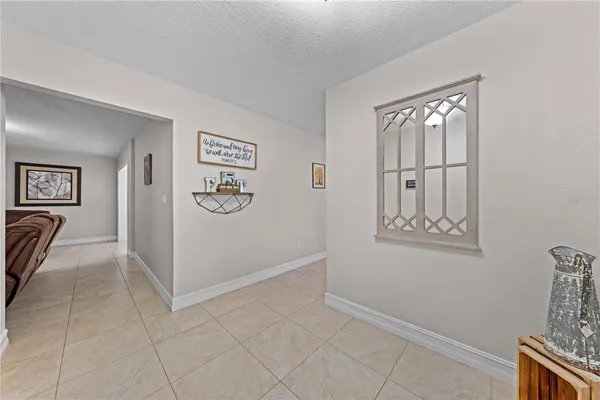 a bedroom with a bed a mirror on dresser and a window