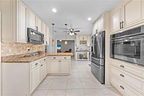 a kitchen with appliances cabinets and a sink