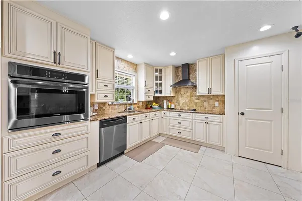 a large kitchen with a large counter top cabinets and stainless steel appliances