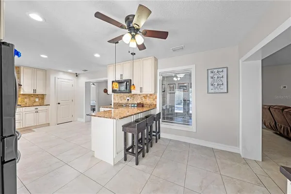 a large kitchen with a table and chairs