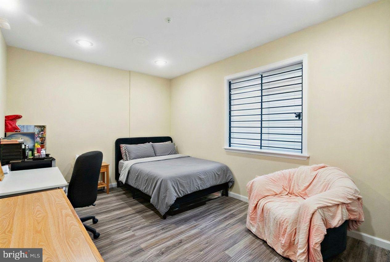 1611 North 17th Street, Unit A Philadelphia, PA 19121 - Photo 15 of 19 a bedroom with a bed and a chair