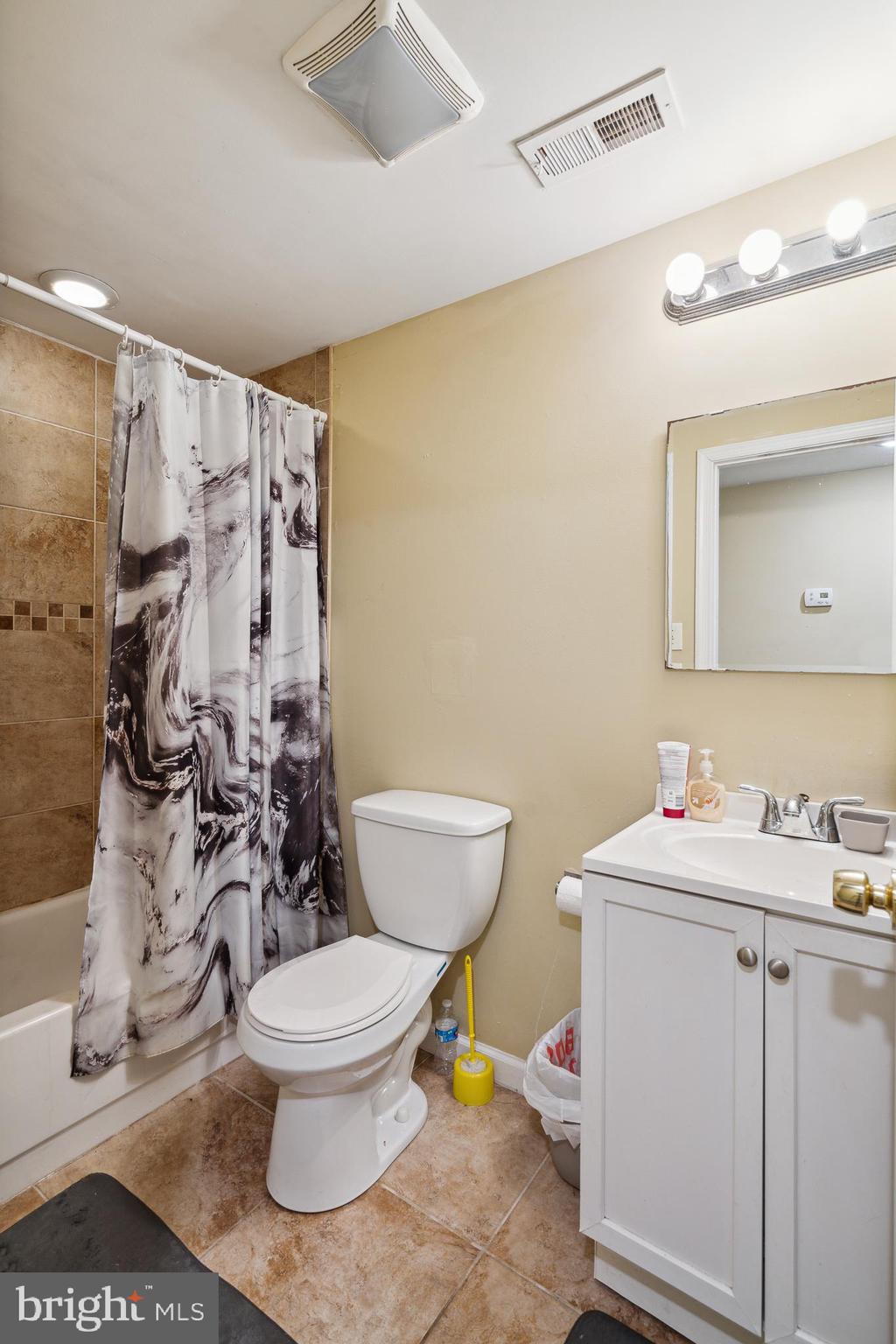 1611 North 17th Street, Unit A Philadelphia, PA 19121 - Photo 18 of 19 a bathroom with a toilet sink and mirror