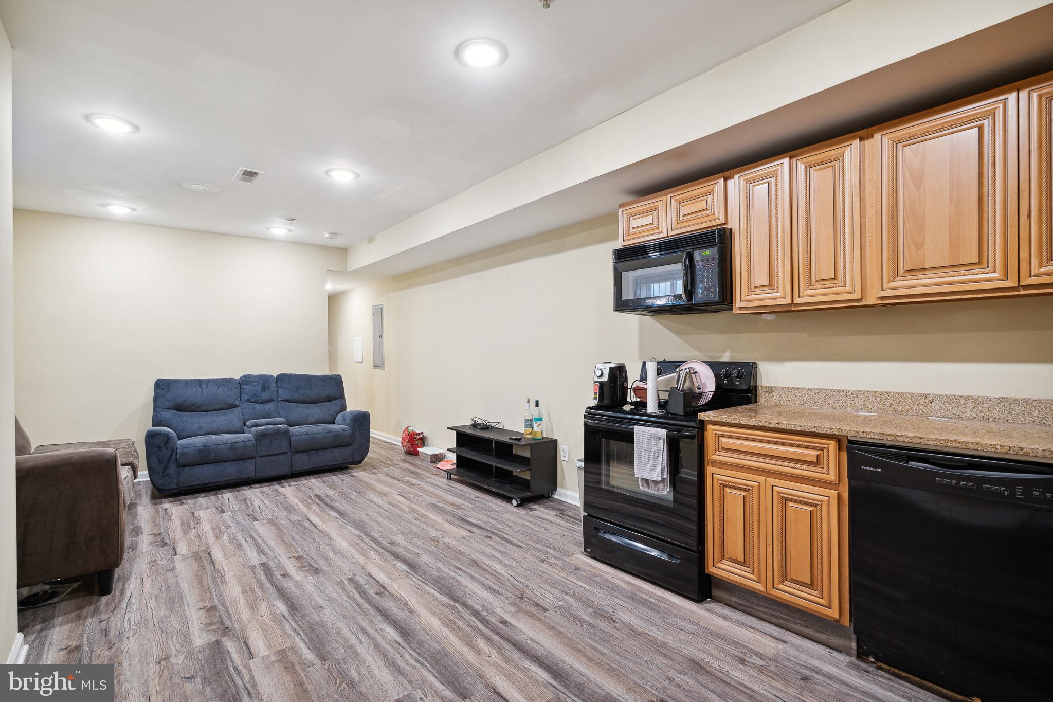 1611 North 17th Street, Unit A Philadelphia, PA 19121 - Photo 3 of 19 a kitchen with a stove and wooden floor