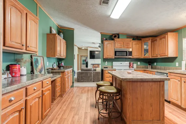 a kitchen with granite countertop a sink and a window