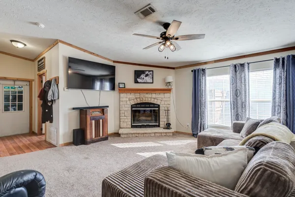 a bedroom with a bed a chandelier and dresser