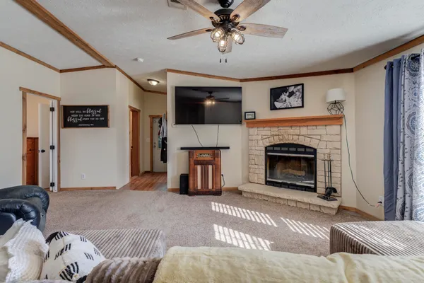 a living room with furniture a flat screen tv and a window