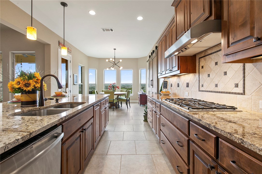 380 Emma Loop Austin, TX 78737 - Photo 1 of 1 a kitchen with stainless steel appliances granite countertop a sink stove and cabinets