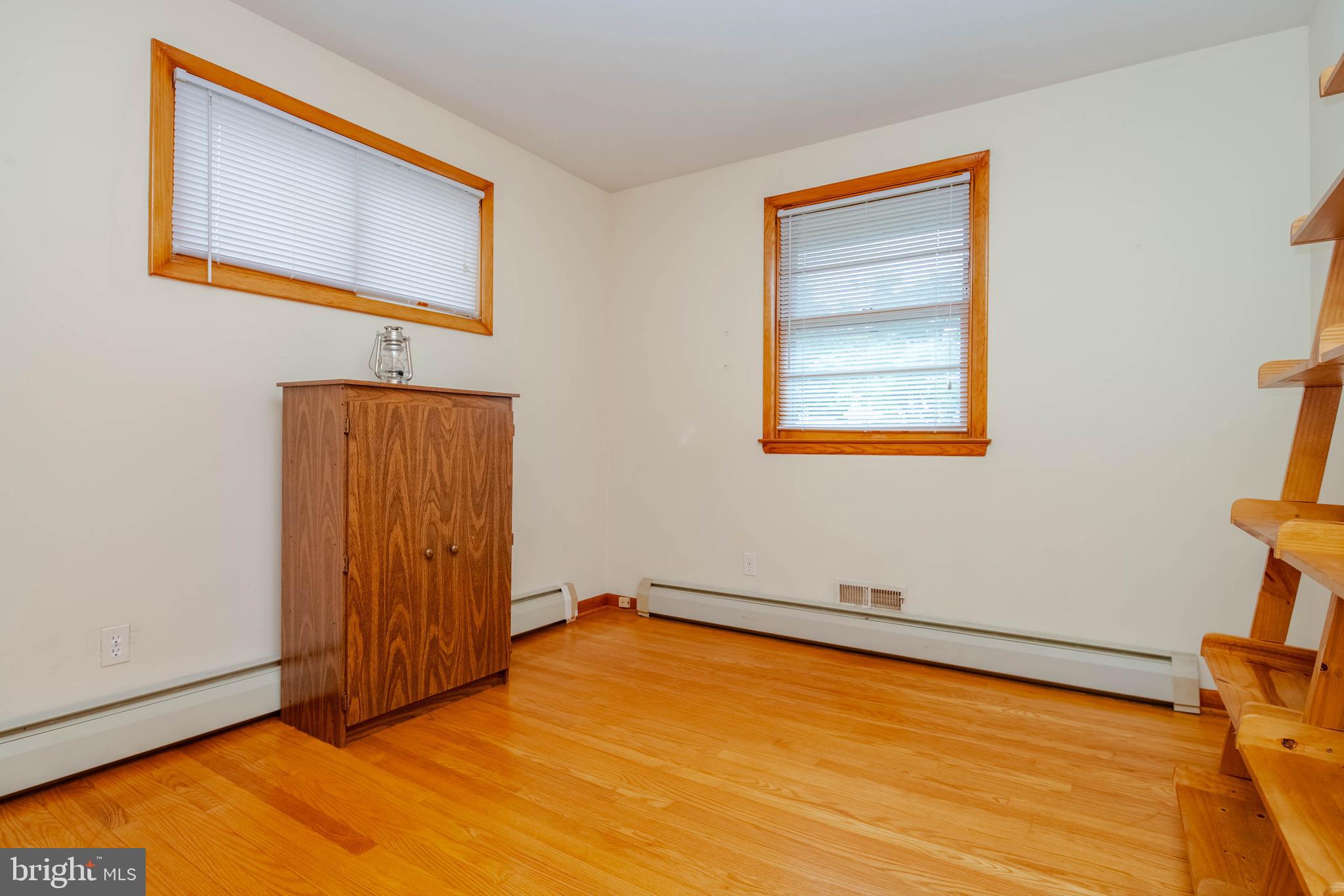 2319 Reckord Road Joppa, MD 21085 - Photo 18 of 45 a view of an empty room with window and wooden floor