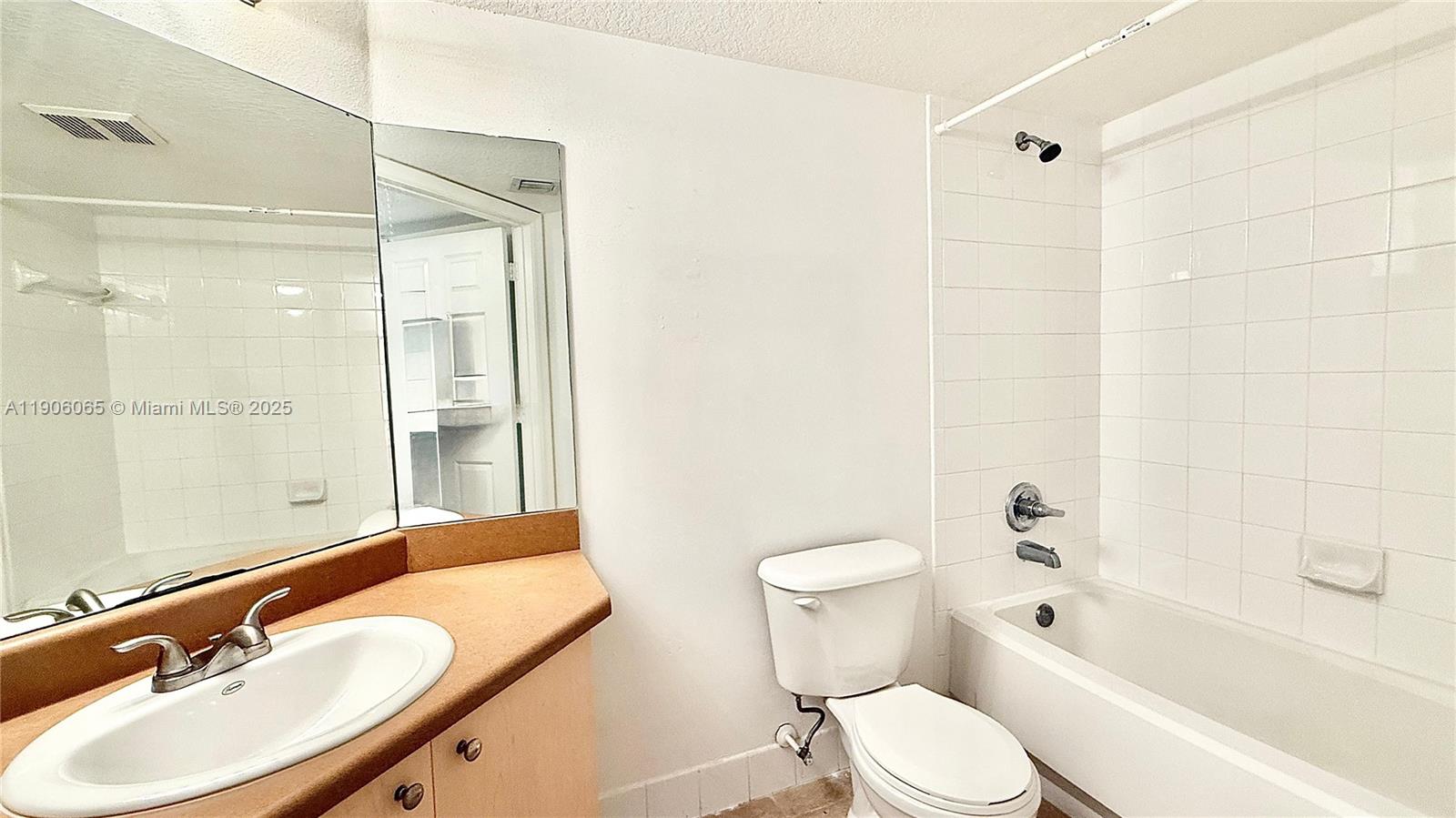 4211 San Marino Boulevard, Unit 205 West Palm Beach, FL 33409 - Photo 16 of 22 a bathroom with a sink toilet and shower