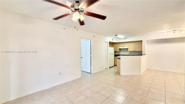 a view of a kitchen with wooden floor and a refrigerator