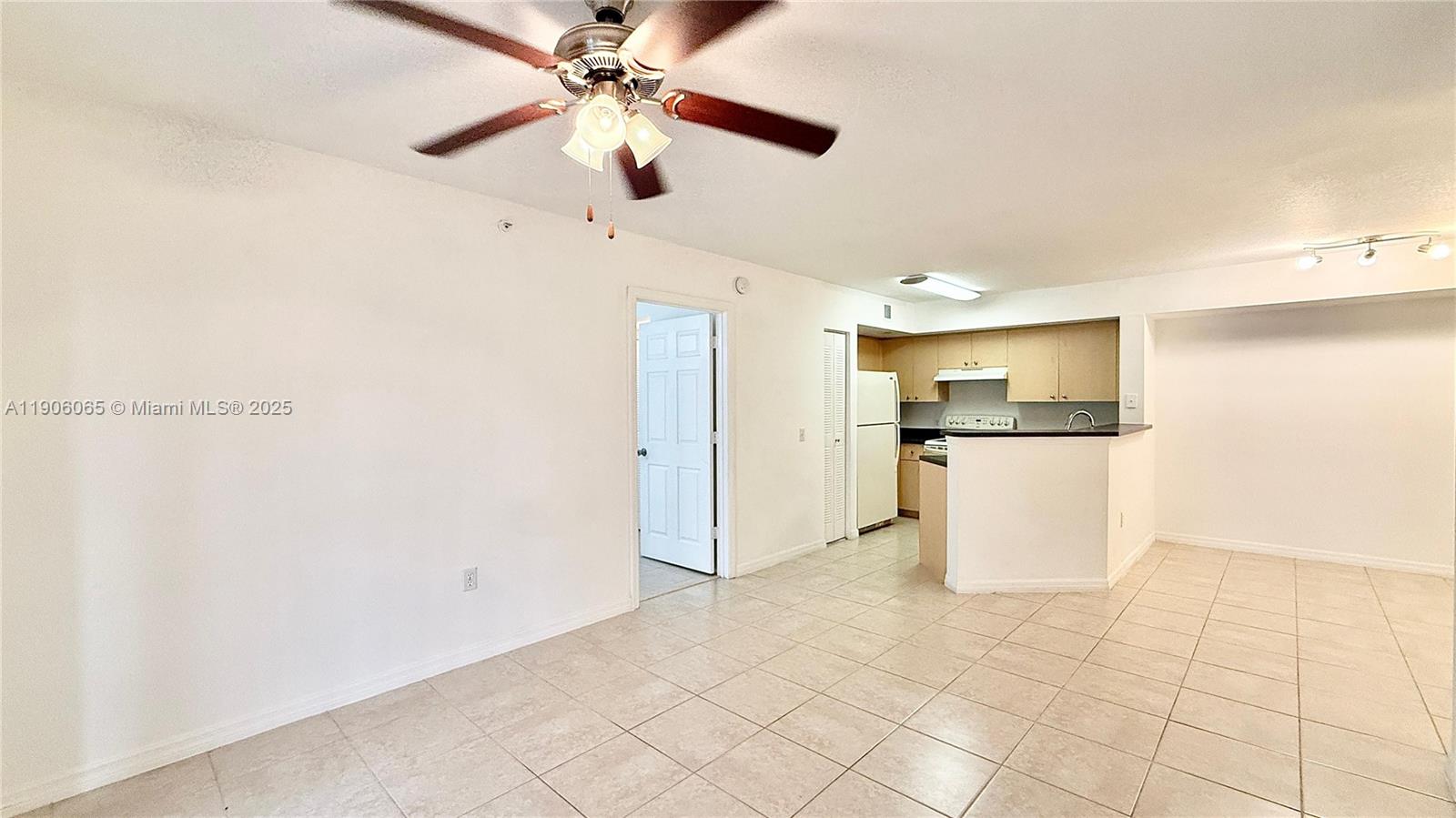 4211 San Marino Boulevard, Unit 205 West Palm Beach, FL 33409 - Photo 2 of 22 a view of a kitchen with wooden floor and a refrigerator