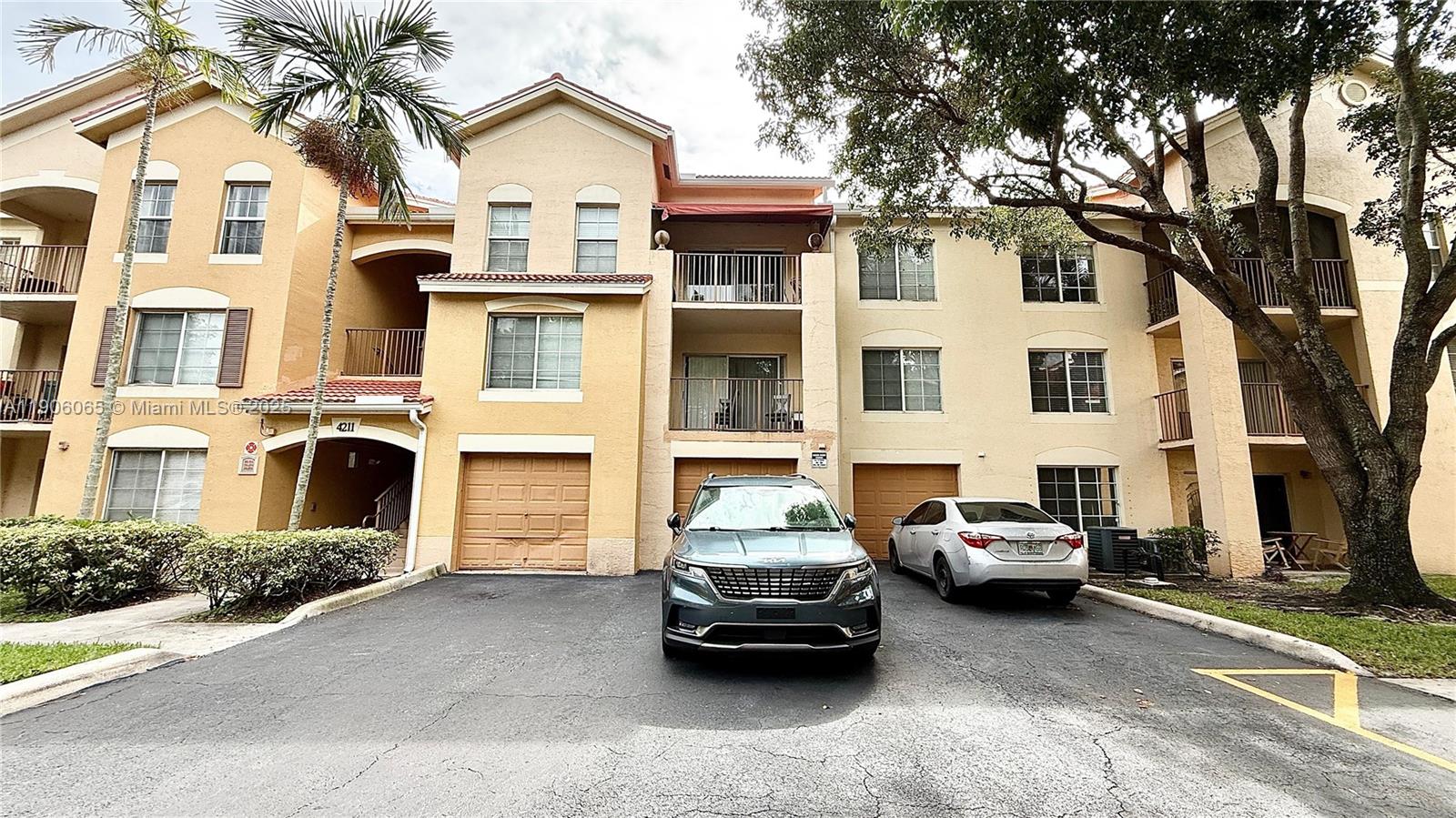 4211 San Marino Boulevard, Unit 205 West Palm Beach, FL 33409 - Photo 21 of 22 a car parked in front of a white house