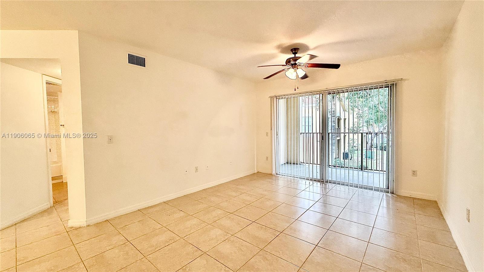 4211 San Marino Boulevard, Unit 205 West Palm Beach, FL 33409 - Photo 6 of 22 a view of a livingroom with a chandelier fan and windows