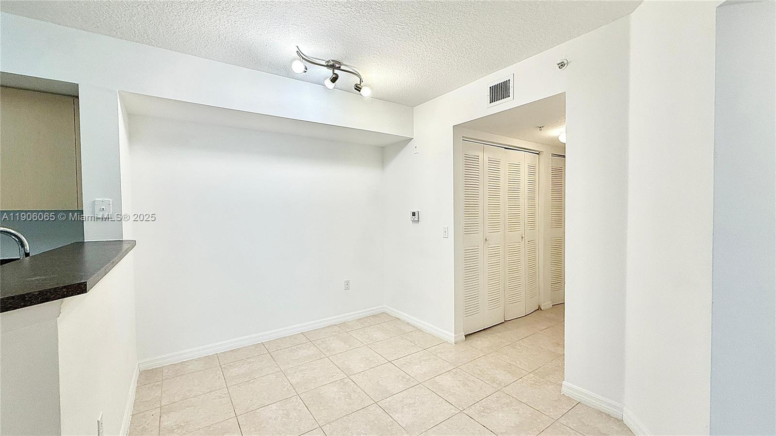 4211 San Marino Boulevard, Unit 205 West Palm Beach, FL 33409 - Photo 7 of 22 a view of a bathroom with a sink and a mirror
