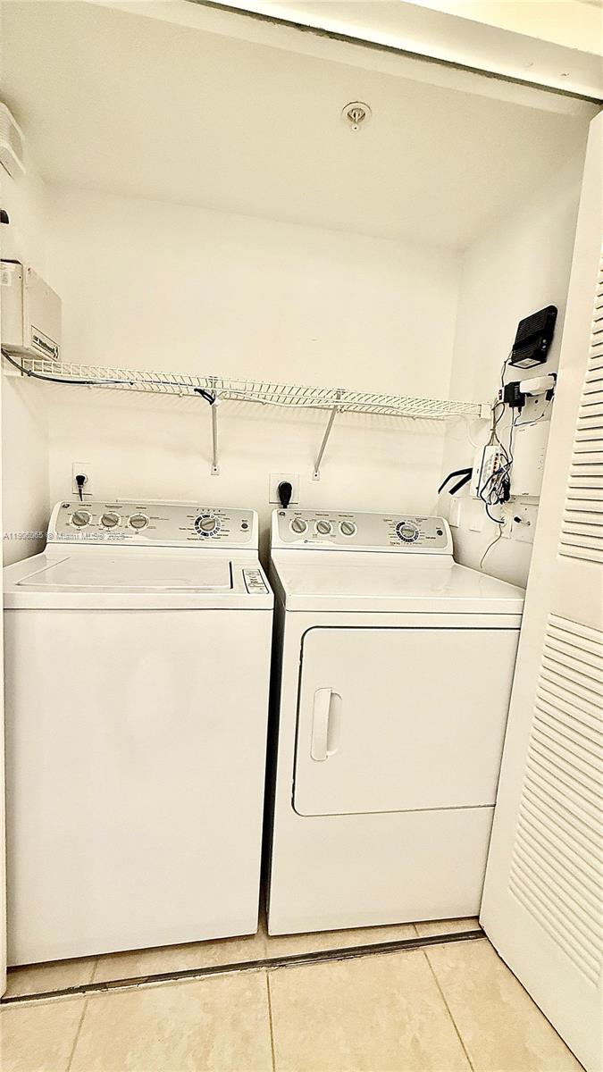 4211 San Marino Boulevard, Unit 205 West Palm Beach, FL 33409 - Photo 9 of 22 a utility room with dryer and washer