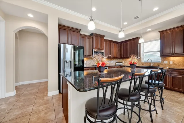 a kitchen with granite countertop a sink and a window