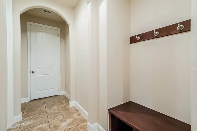 a bathroom with a granite countertop tub sink and mirror
