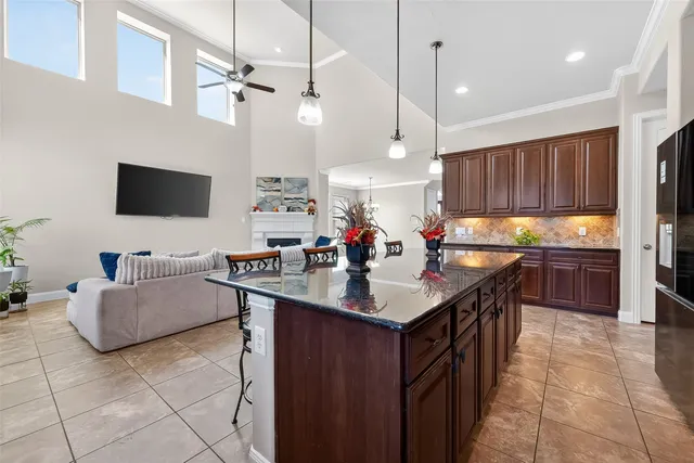 a view of an empty room with window and chandelier