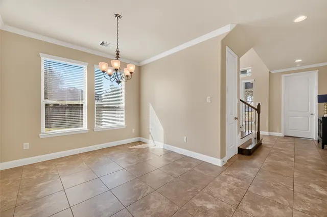 a view of a kitchen and dining area with a chandelier fan