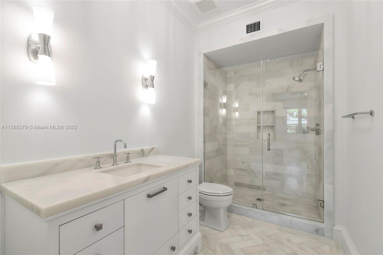 2607 Anderson Road Coral Gables, FL 33134 - Photo 17 of 96 a bathroom with a sink a toilet and shower