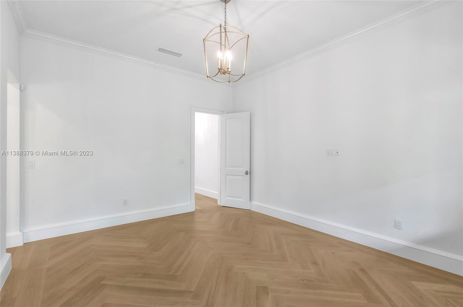 2607 Anderson Road Coral Gables, FL 33134 - Photo 67 of 96 a view of an empty room with a chandelier fan