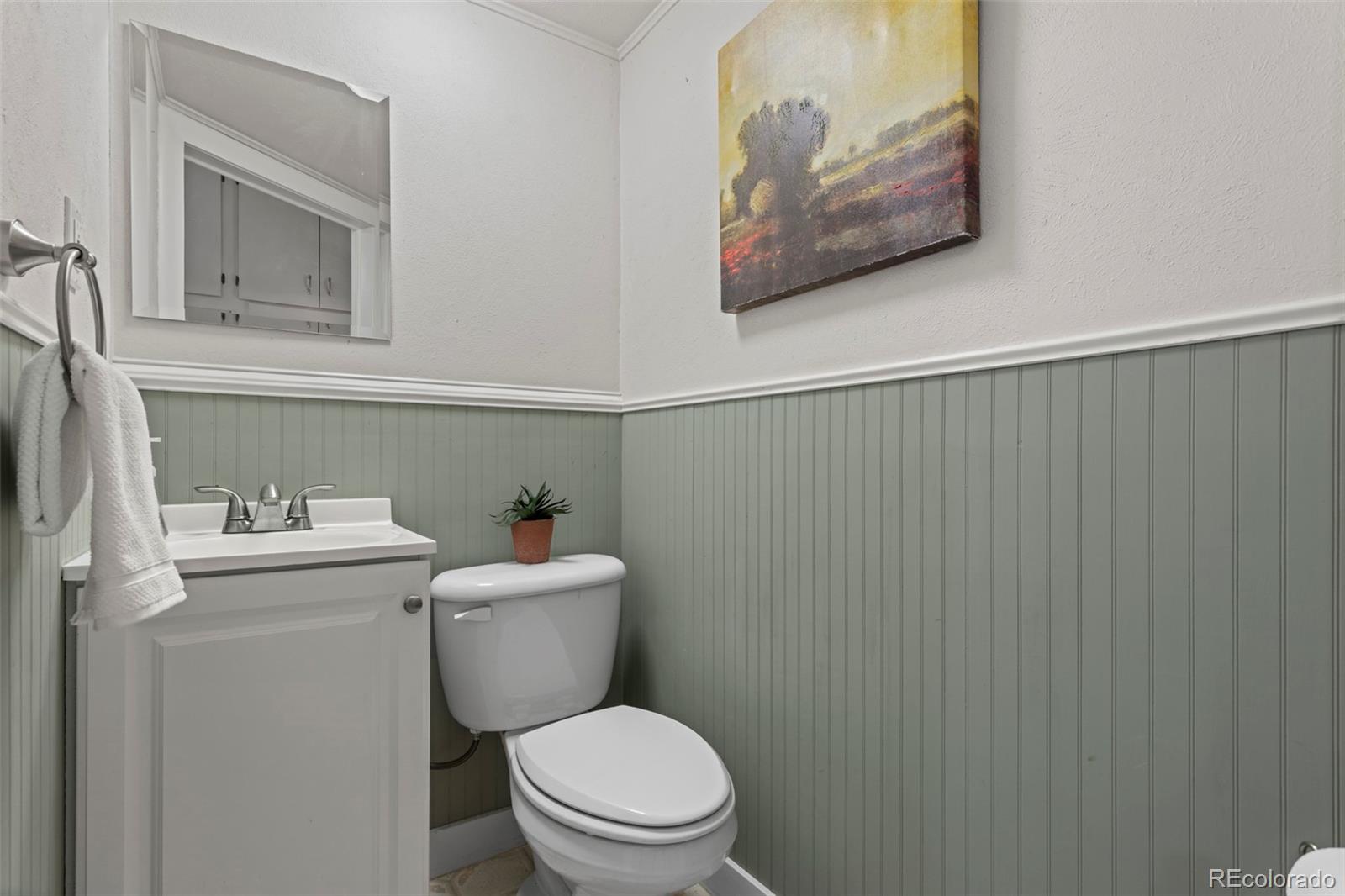 3273 Jay Street Wheat Ridge, CO 80033 - Photo 9 of 18 a white toilet sitting next to a bathroom sink