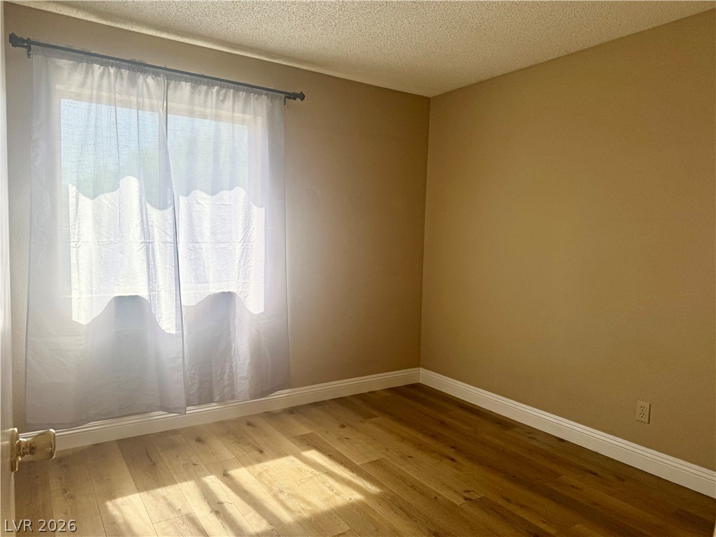 135 Primero Way Henderson, NV 89074 - Photo 10 of 15 Sun-drenched interiors reveal pristine hardwood flooring, ready for your personalized touch.