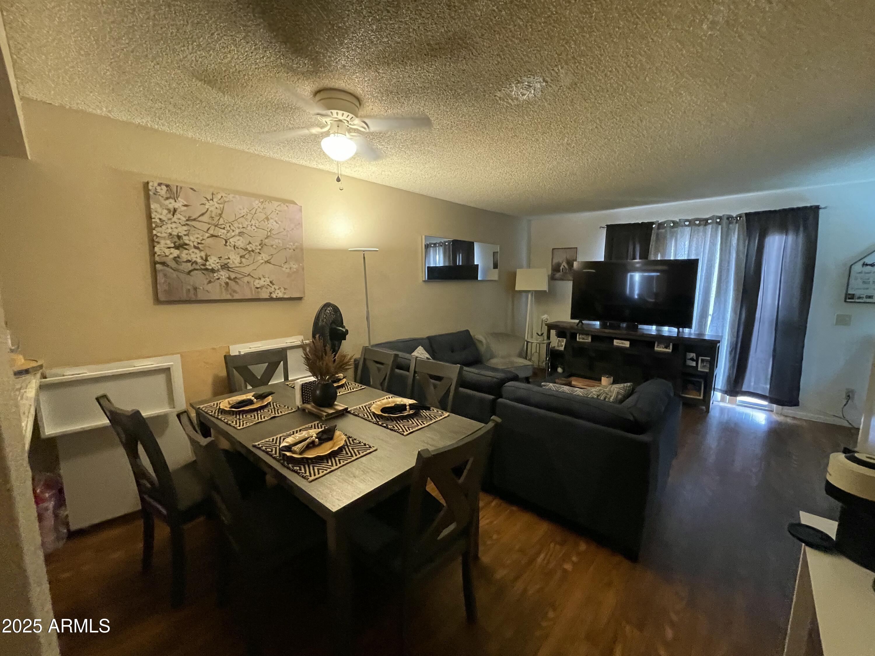 2822 East Kathleen Road Phoenix, AZ 85032 - Photo 12 of 30 a living room with furniture and a flat screen tv