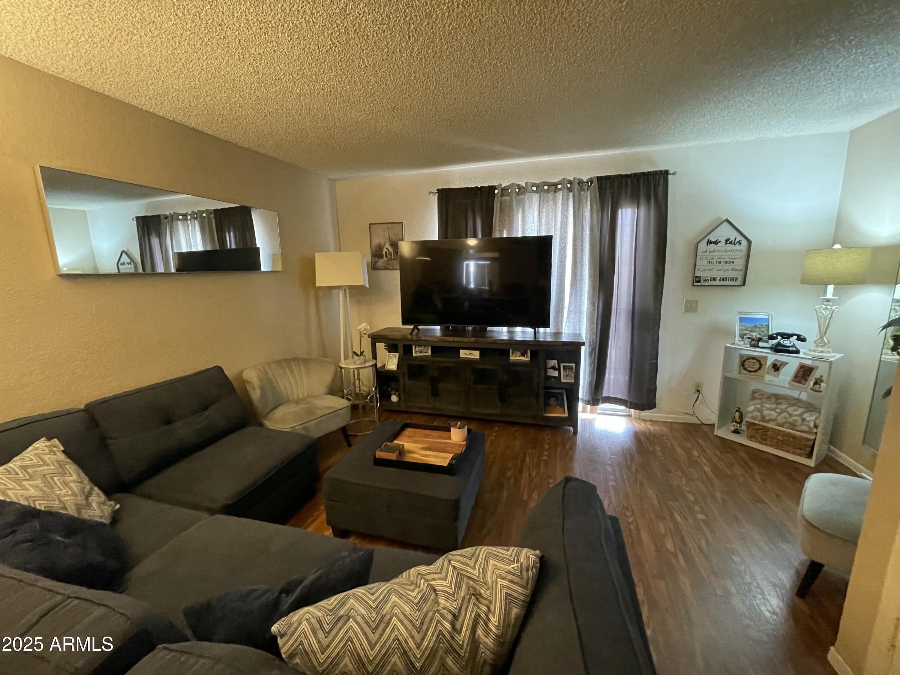 2822 East Kathleen Road Phoenix, AZ 85032 - Photo 13 of 30 a living room with furniture and a flat screen tv