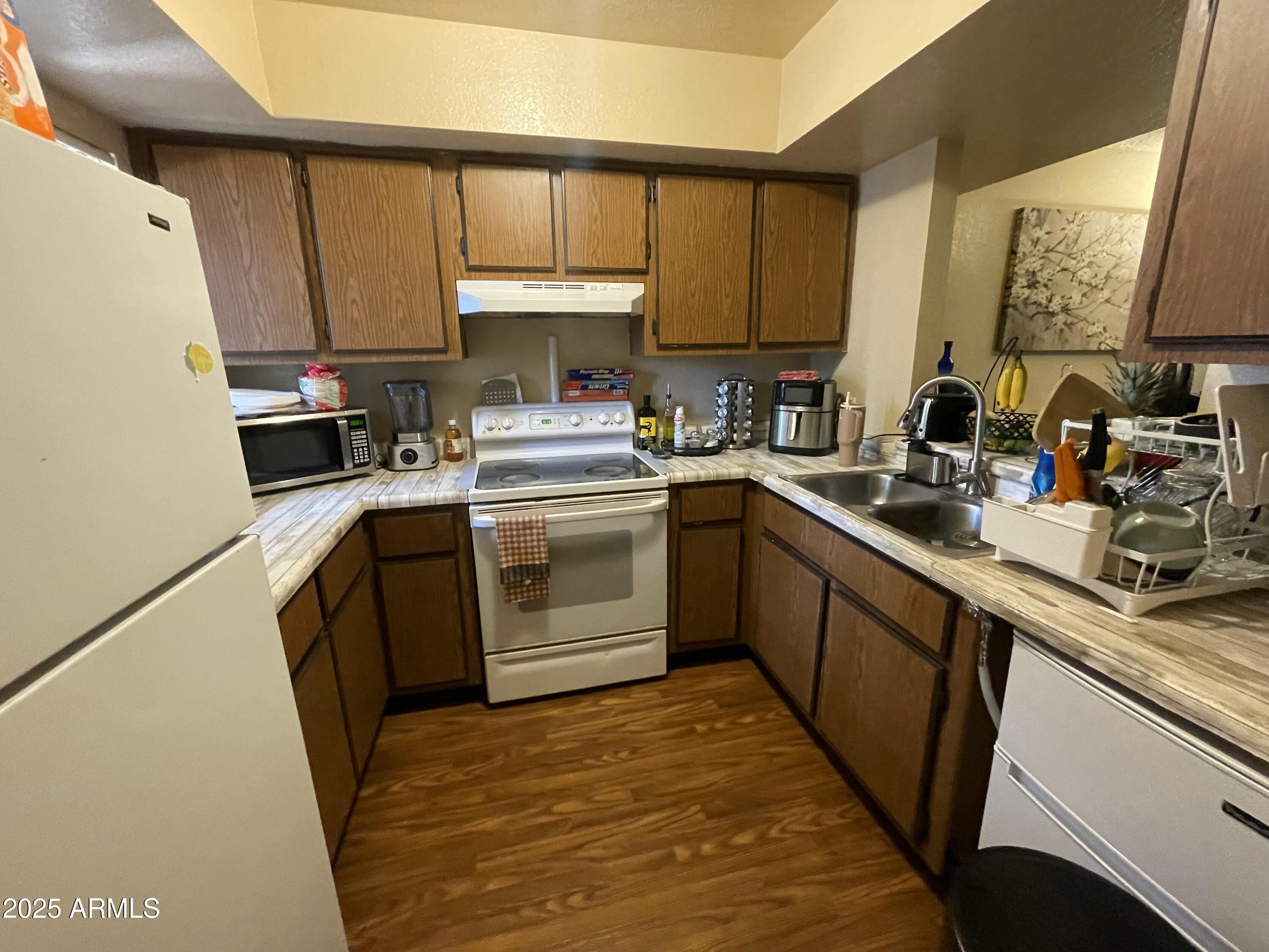 2822 East Kathleen Road Phoenix, AZ 85032 - Photo 15 of 30 a kitchen with a sink appliances cabinets and a window