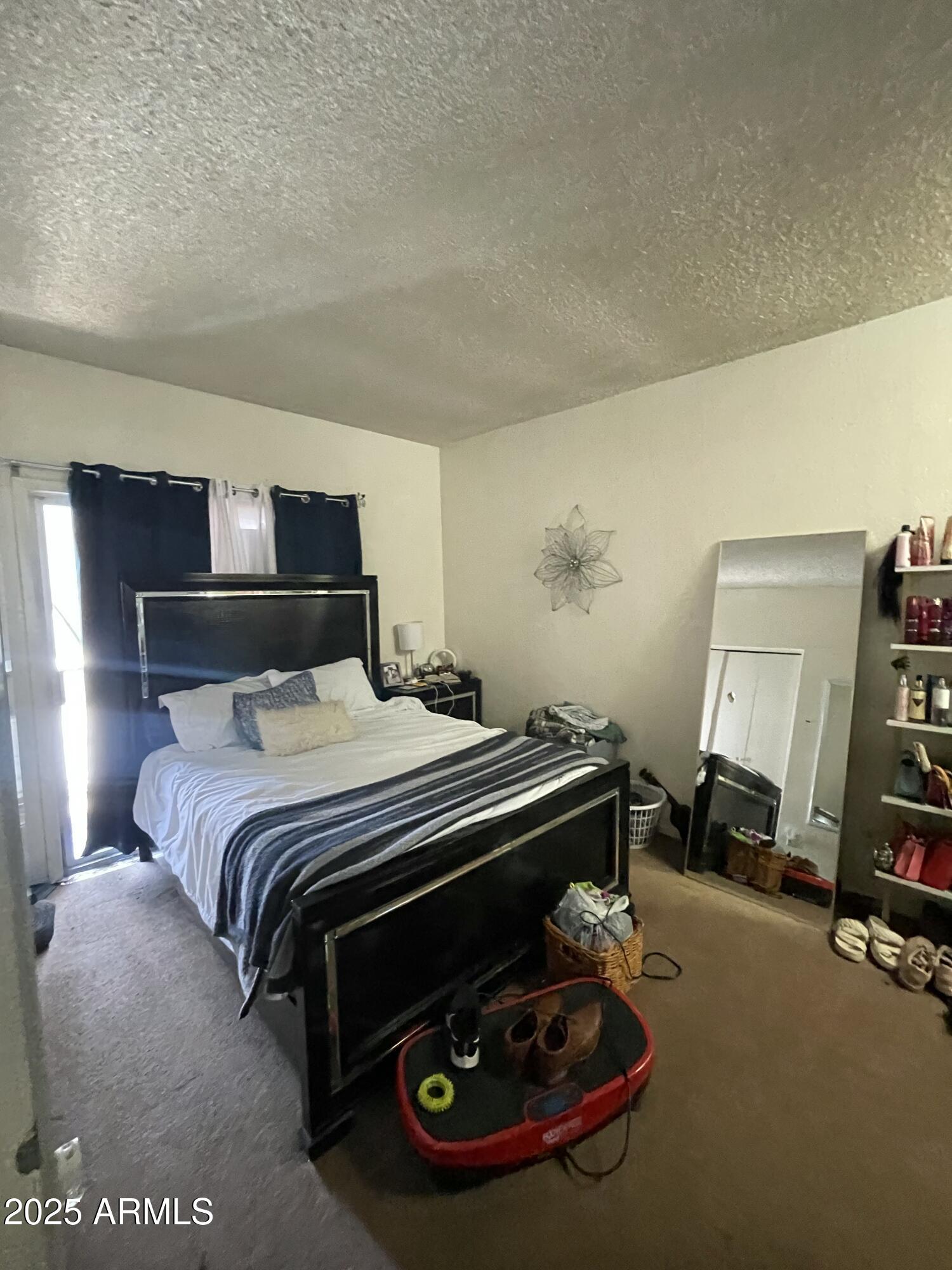 2822 East Kathleen Road Phoenix, AZ 85032 - Photo 29 of 30 a bed sitting in a bedroom next to a window