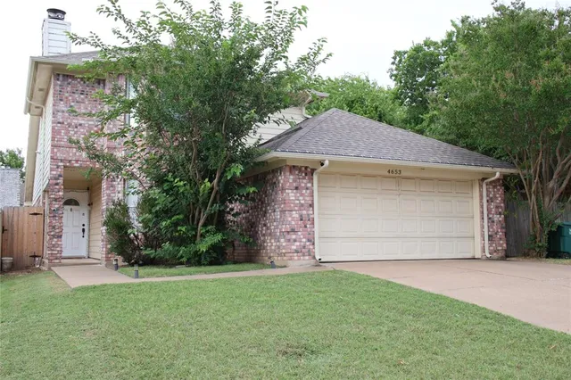 a aerial view of a house with a yard and a garage