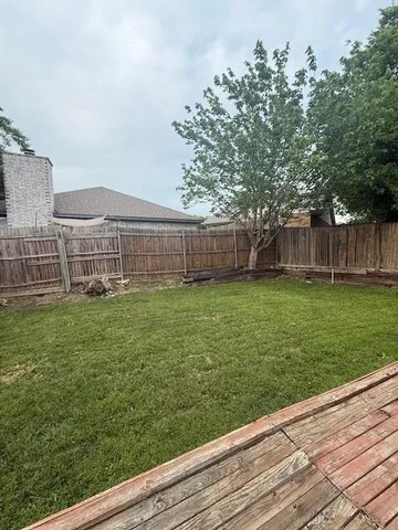 a view of a backyard with a garden and entertaining space