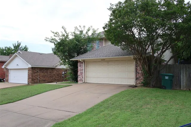 a front view of house with yard and trees