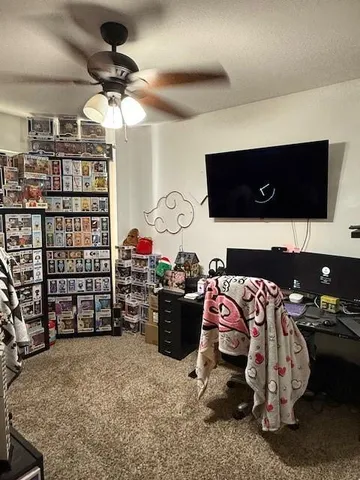 a bedroom with furniture and a flat screen tv