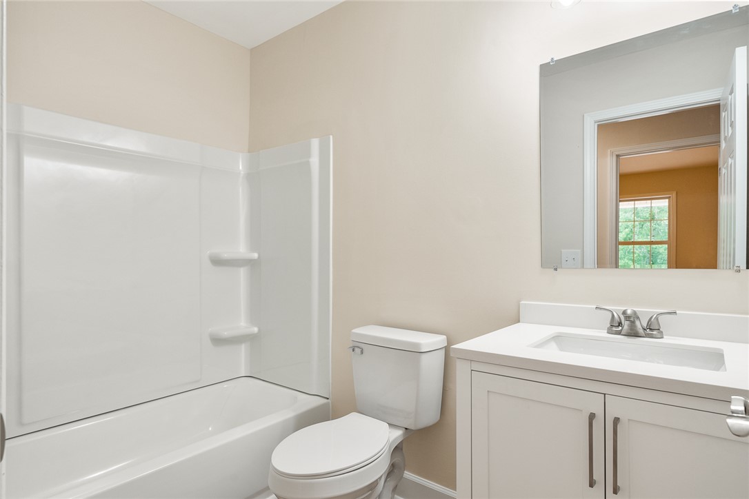 131 Lockaby Road Pelzer, SC 29669 - Photo 32 of 50 This clean and functional bathroom features a shower-tub combination and vanity with ample storage.