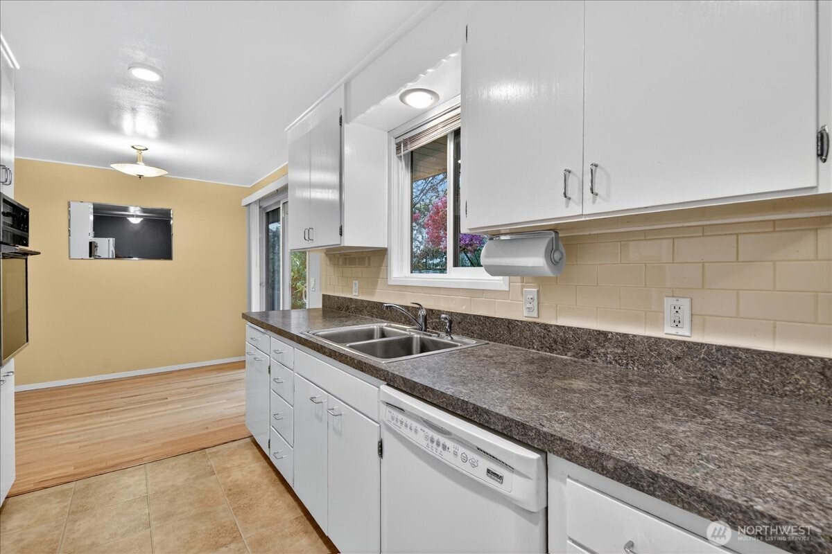 20721 81st Avenue West Edmonds, WA 98026 - Photo 9 of 25 a kitchen with granite countertop a sink and cabinets