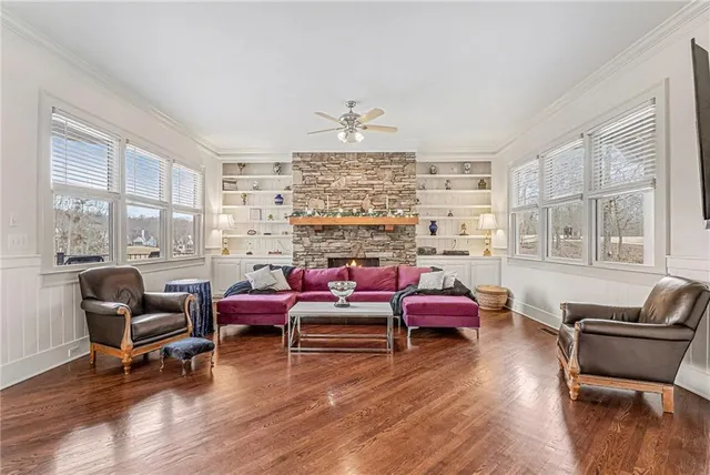 a view of a swimming pool with a yard and large trees