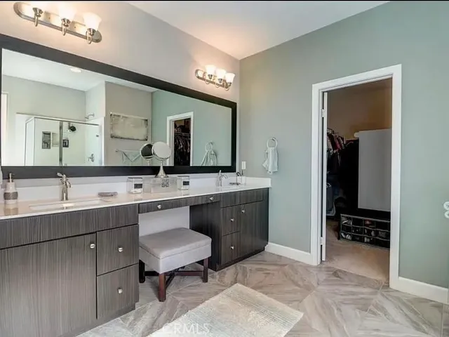 a bathroom with a sink double vanity and a mirror