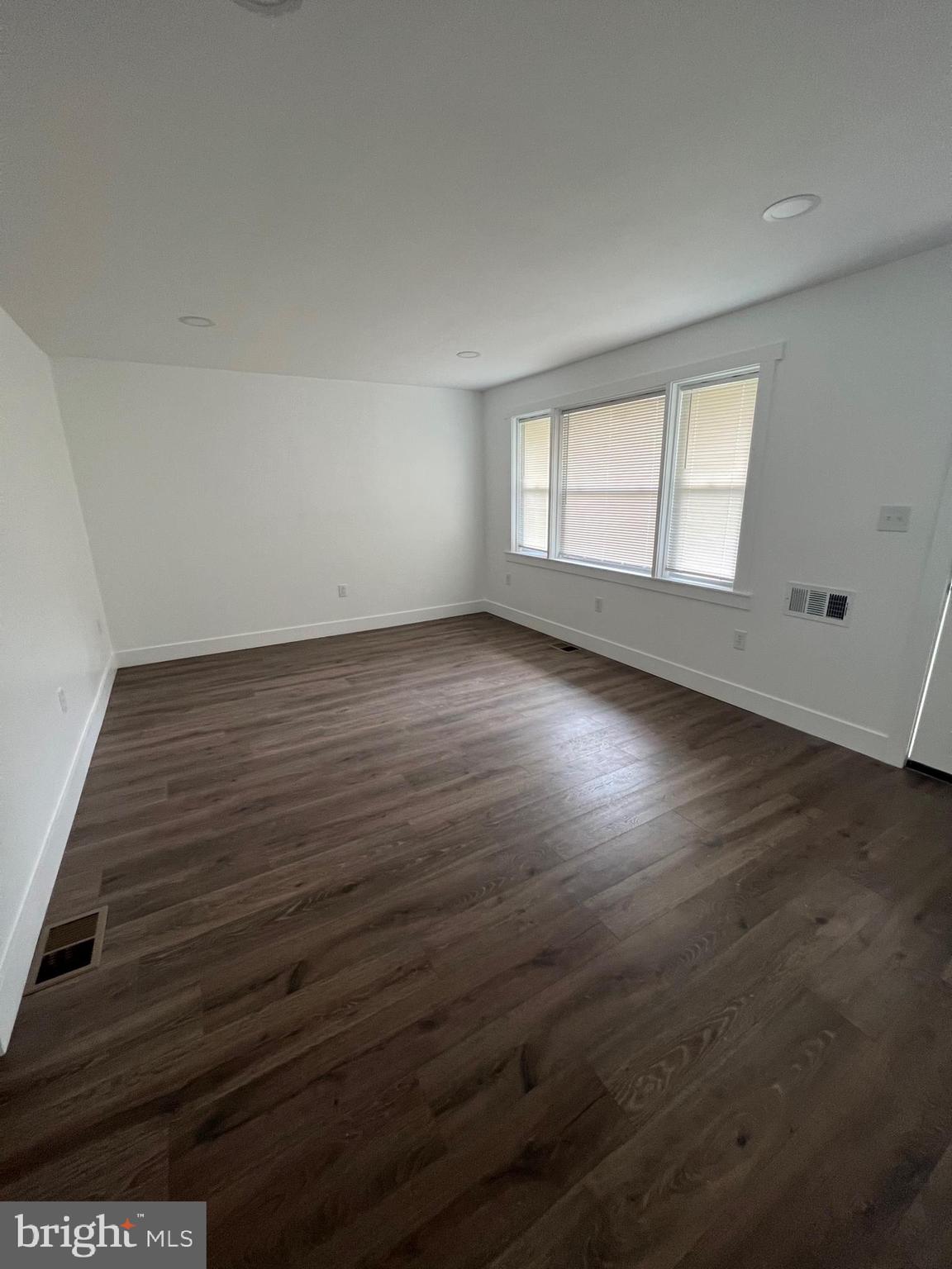 1024 Crestview Avenue Reading, PA 19607 - Photo 9 of 11 an empty room with wooden floor and windows