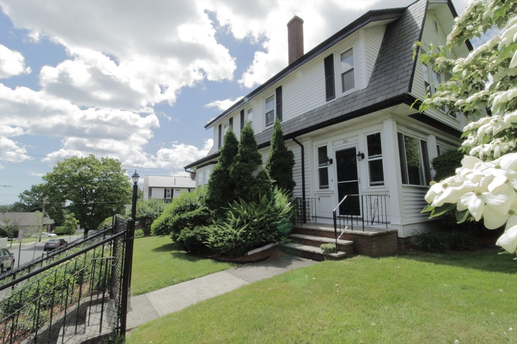 36 Kimball Road Chelsea, MA 02150 - Photo 2 of 24 a view of a house with brick walls and a yard with plants